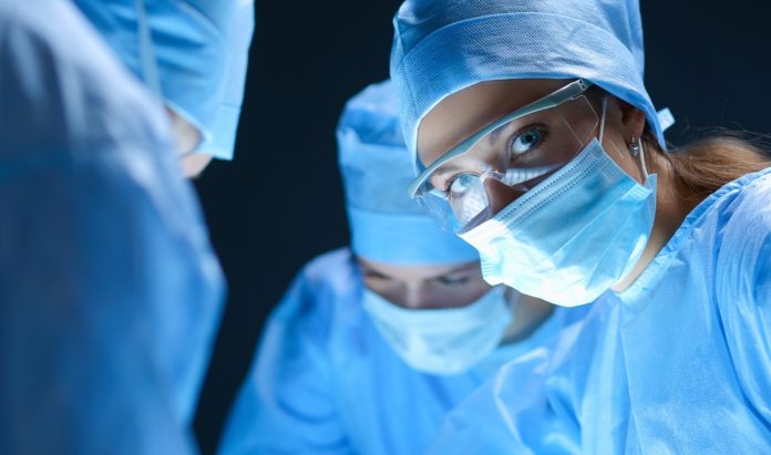 A blue-eyed surgeon sensing something strange during an operation