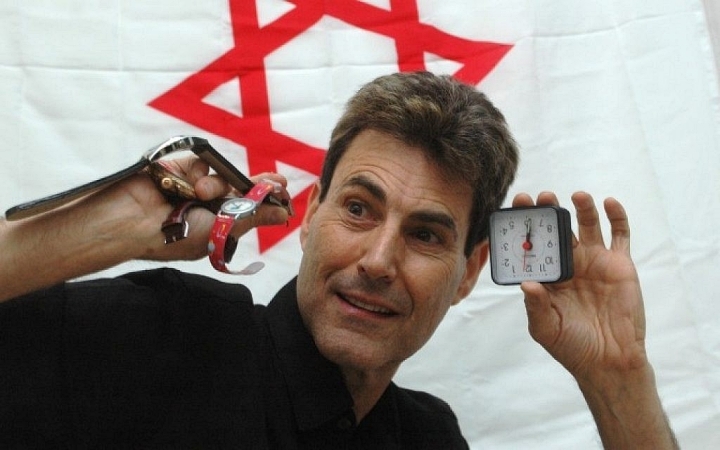 Uri Geller showing off watches and a clock that allegedly restarted via his mind power